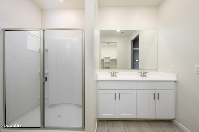 bathroom featuring vanity, a shower with shower door, and hardwood / wood-style floors