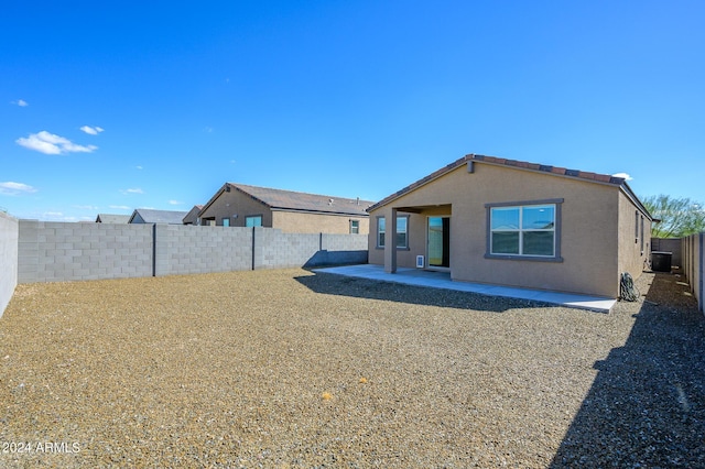 12568 W Orangewood Ave, Glendale, AZ 85307 - rear view of house featuring a fenced backyard, central AC unit, and a patio area