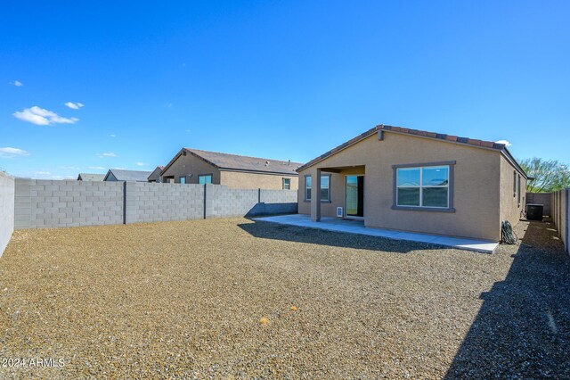 12568 W Orangewood Ave, Glendale, AZ 85307 - rear view of house featuring a fenced backyard, central AC unit, and a patio area