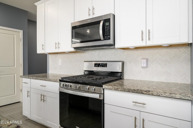 12568 W Orangewood Ave, Glendale, AZ 85307 - kitchen featuring decorative backsplash, light stone countertops, stainless steel appliances, and white cabinetry