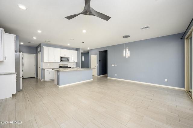 kitchen featuring ceiling fan, stainless steel appliances, decorative light fixtures, and white cabinets