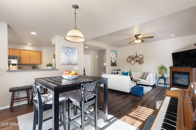 4435 E Savannah Cir, Flagstaff, AZ 86004 - dining room with dark wood finished floors, baseboards, a glass covered fireplace, recessed lighting, and a ceiling fan