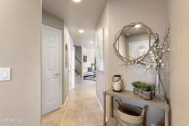 4435 E Savannah Cir, Flagstaff, AZ 86004 - corridor featuring stairway, light tile patterned floors, a textured wall, baseboards, and recessed lighting