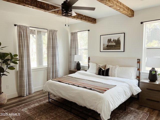 bedroom featuring ceiling fan, beam ceiling, and dark wood-type flooring