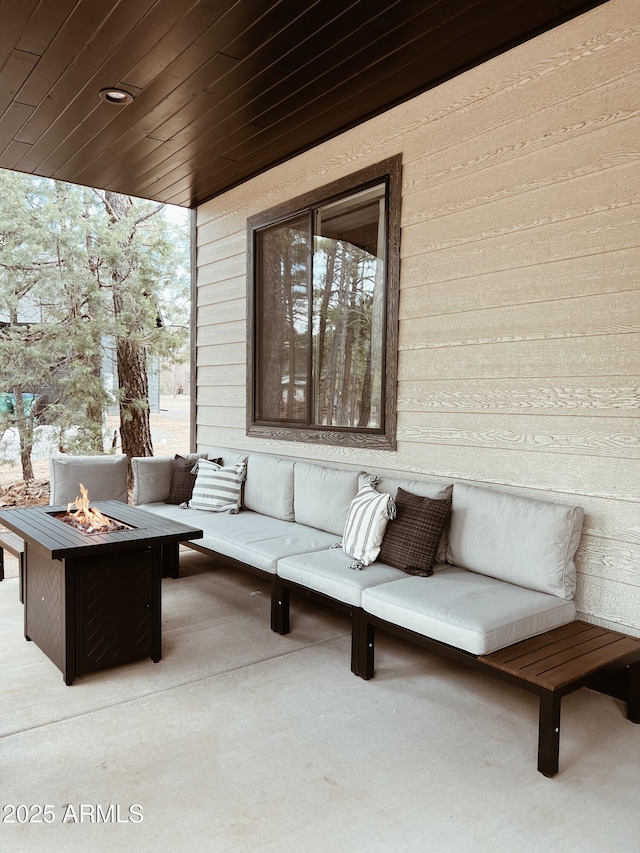 view of patio / terrace with an outdoor living space with a fire pit