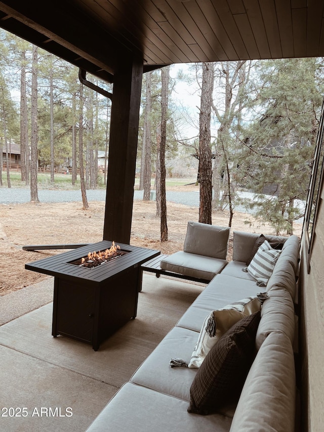 view of patio / terrace featuring an outdoor living space with a fire pit