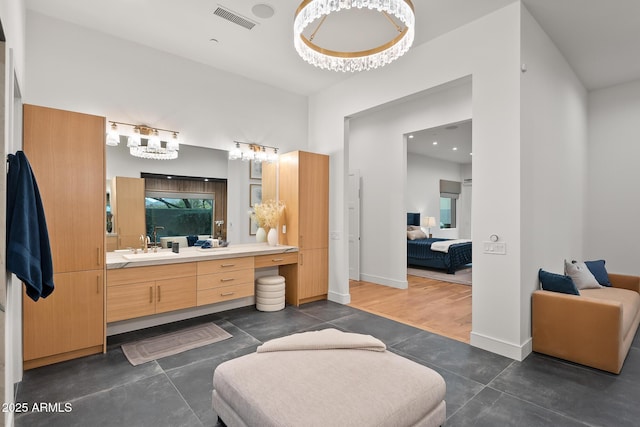 full bathroom featuring connected bathroom, baseboards, visible vents, and vanity