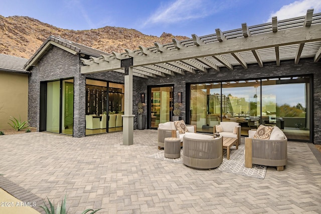 view of patio featuring a mountain view, a pergola, and an outdoor hangout area