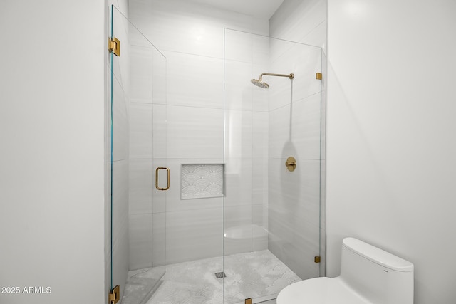 bathroom featuring a shower stall and toilet