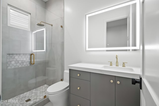 bathroom featuring vanity, toilet, and a shower stall