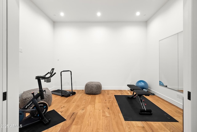 workout area featuring recessed lighting, wood finished floors, and baseboards