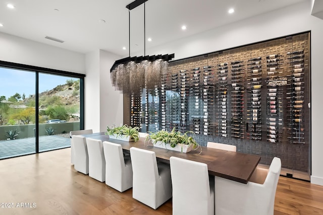 wine cellar with electric panel, visible vents, recessed lighting, and wood finished floors