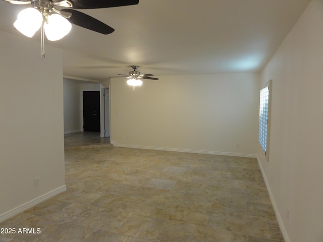 spare room featuring baseboards and ceiling fan