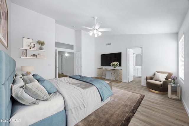 6368 W Firebird Dr, Glendale, AZ 85308 - bedroom with wood finished floors, baseboards, a ceiling fan, high vaulted ceiling, and ensuite bathroom