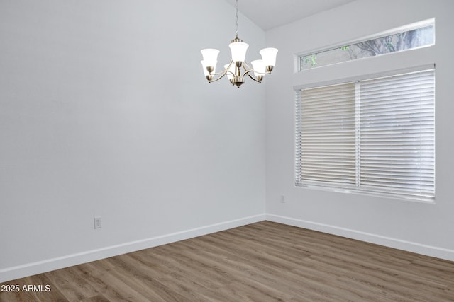 6368 W Firebird Dr, Glendale, AZ 85308 - spare room featuring a chandelier, baseboards, and wood finished floors