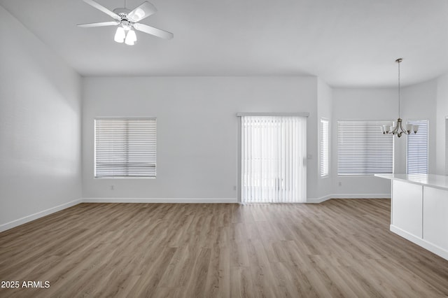 6368 W Firebird Dr, Glendale, AZ 85308 - unfurnished room featuring a chandelier, wood finished floors, baseboards, and a ceiling fan