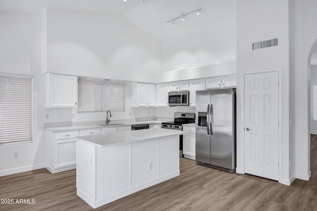 6368 W Firebird Dr, Glendale, AZ 85308 - kitchen with stainless steel appliances, high vaulted ceiling, a sink, rail lighting, and baseboards