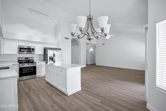 6368 W Firebird Dr, Glendale, AZ 85308 - kitchen with stainless steel appliances, track lighting, light countertops, a chandelier, and white cabinetry