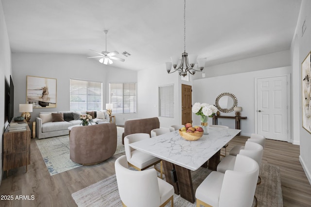 6368 W Firebird Dr, Glendale, AZ 85308 - dining space with a chandelier, wood finished floors, ceiling fan, and vaulted ceiling