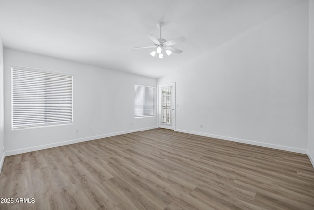 6368 W Firebird Dr, Glendale, AZ 85308 - empty room with ceiling fan, wood finished floors, baseboards, and vaulted ceiling