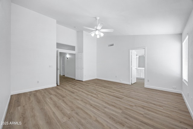 6368 W Firebird Dr, Glendale, AZ 85308 - unfurnished room with a ceiling fan, light wood-style flooring, baseboards, and high vaulted ceiling