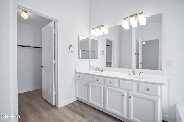 6368 W Firebird Dr, Glendale, AZ 85308 - full bath featuring wood finished floors, double vanity, a spacious closet, baseboards, and toilet
