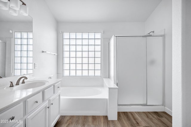6368 W Firebird Dr, Glendale, AZ 85308 - full bathroom featuring wood finished floors, vanity, a garden tub, a stall shower, and plenty of natural light