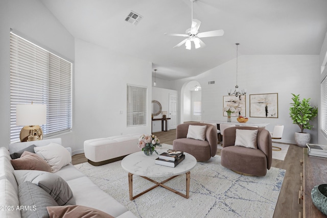 6368 W Firebird Dr, Glendale, AZ 85308 - living area with vaulted ceiling, wood finished floors, ceiling fan, arched walkways, and a chandelier