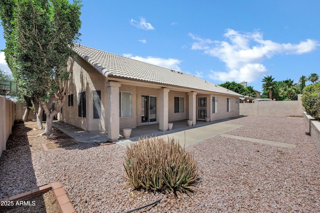 6368 W Firebird Dr, Glendale, AZ 85308 - rear view of property featuring a tile roof, a fenced backyard, stucco siding, and a patio