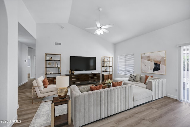 6368 W Firebird Dr, Glendale, AZ 85308 - living room with light wood-type flooring, ceiling fan, baseboards, and high vaulted ceiling