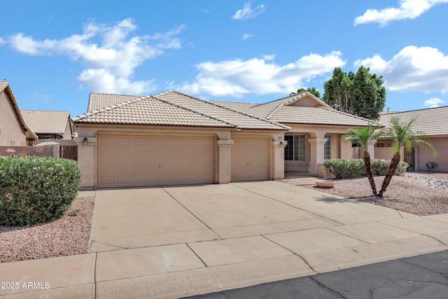 6368 W Firebird Dr, Glendale, AZ 85308 - view of front facade with an attached garage, a tiled roof, driveway, and stucco siding