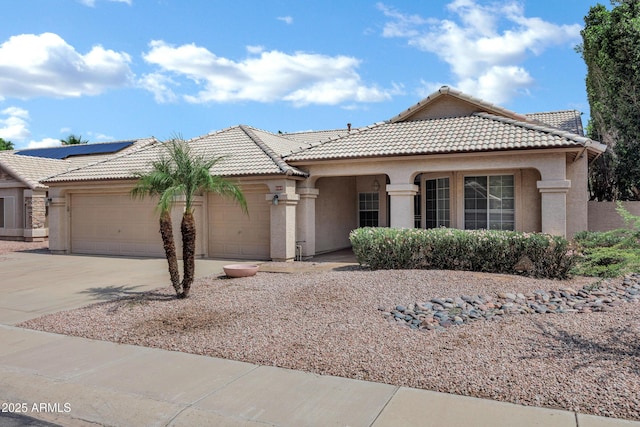 6368 W Firebird Dr, Glendale, AZ 85308 - view of front of home featuring an attached garage, a tile roof, concrete driveway, and stucco siding