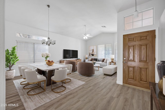 6368 W Firebird Dr, Glendale, AZ 85308 - dining area featuring light wood-style floors, ceiling fan, a chandelier, high vaulted ceiling, and baseboards