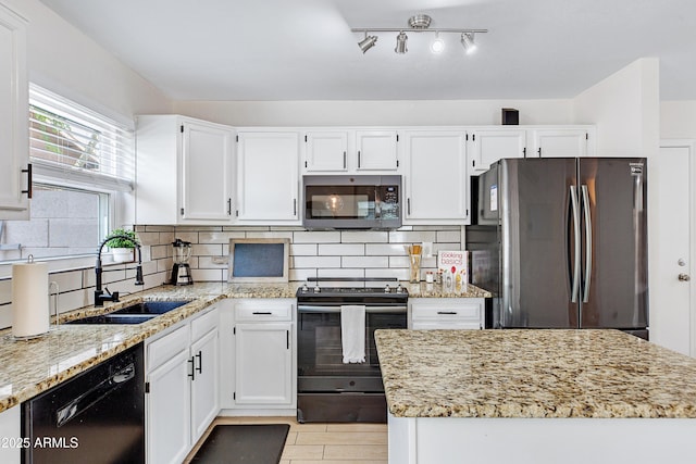 kitchen featuring a sink, white cabinets, black appliances, and light stone countertops