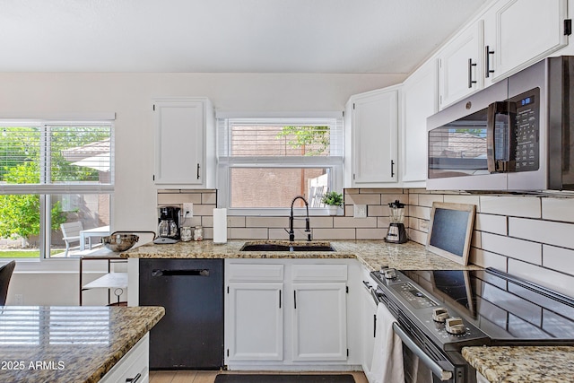kitchen featuring electric range, a healthy amount of sunlight, stainless steel microwave, a sink, and dishwasher