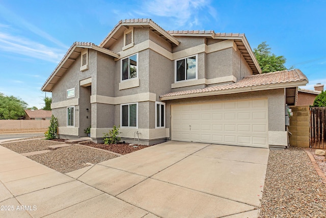 traditional-style house featuring a tiled roof, fence, driveway, and stucco siding