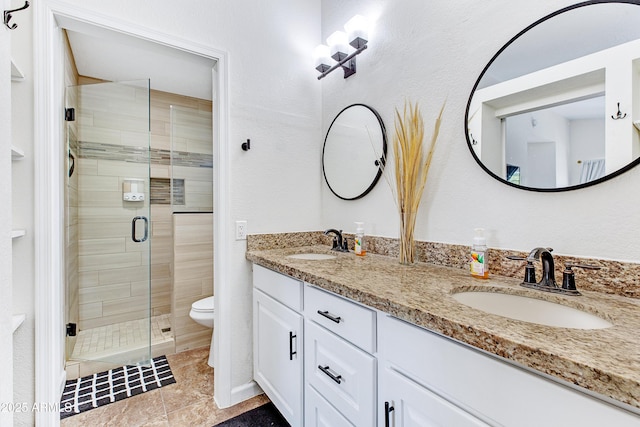 bathroom featuring a sink, a stall shower, and toilet