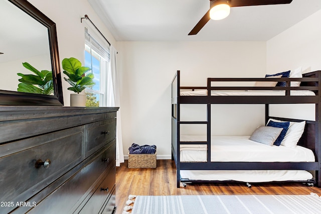 bedroom featuring a ceiling fan and wood finished floors