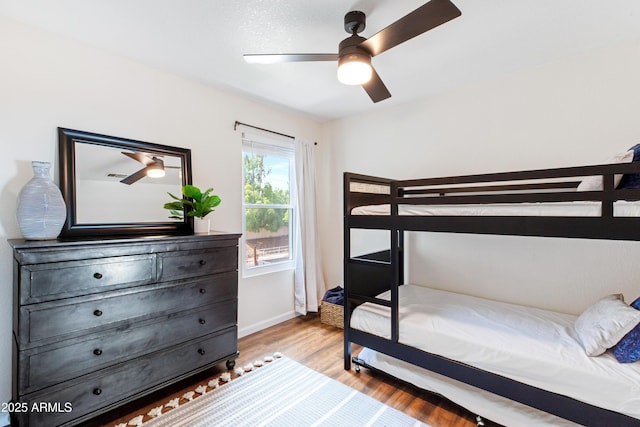 bedroom featuring baseboards, a ceiling fan, and wood finished floors
