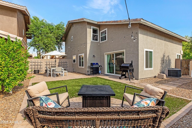 rear view of house featuring a fenced backyard, central AC unit, stucco siding, and a patio area