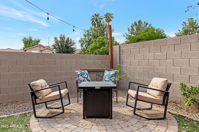 view of patio featuring fence and an outdoor fire pit