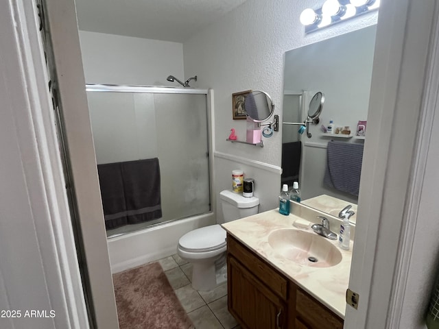 full bathroom with tile patterned flooring, vanity, enclosed tub / shower combo, and toilet