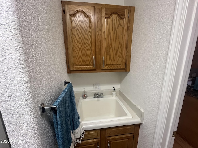 clothes washing area featuring sink