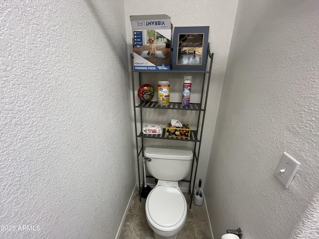 bathroom featuring tile patterned flooring and toilet