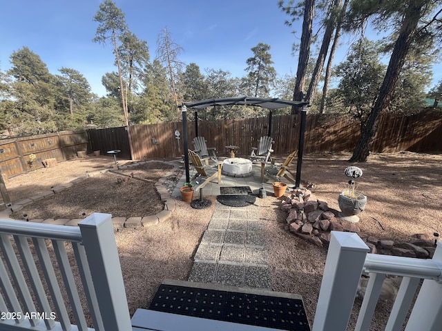 view of yard featuring an outdoor fire pit and a patio