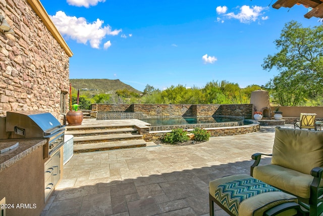 view of patio / terrace featuring a mountain view and area for grilling