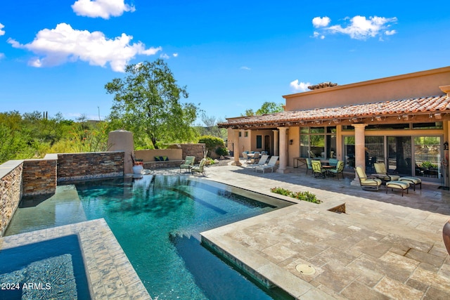 view of pool featuring a patio area and a hot tub