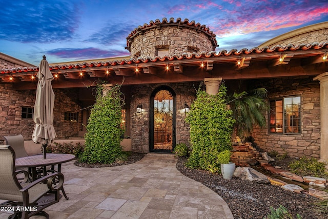 view of patio terrace at dusk