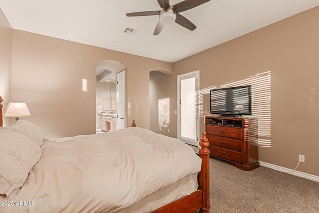 carpeted bedroom with ceiling fan and ensuite bathroom