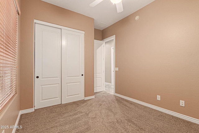 unfurnished bedroom featuring carpet, a closet, and ceiling fan